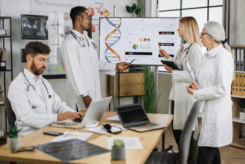 Group of multicultural medical workers discussing gene modification while gathering at hospital meeting room. Qualified doctors researching dna peculiarities during international conference.